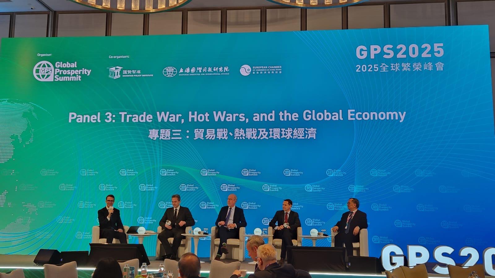 Photo of a silhouette of 2 dancers posing in front of a red curtain.